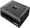 Black Thermaltake computer power supply with ventilation slots and the inscription 'Toughpower TF 1155W', focusing on energy efficiency.