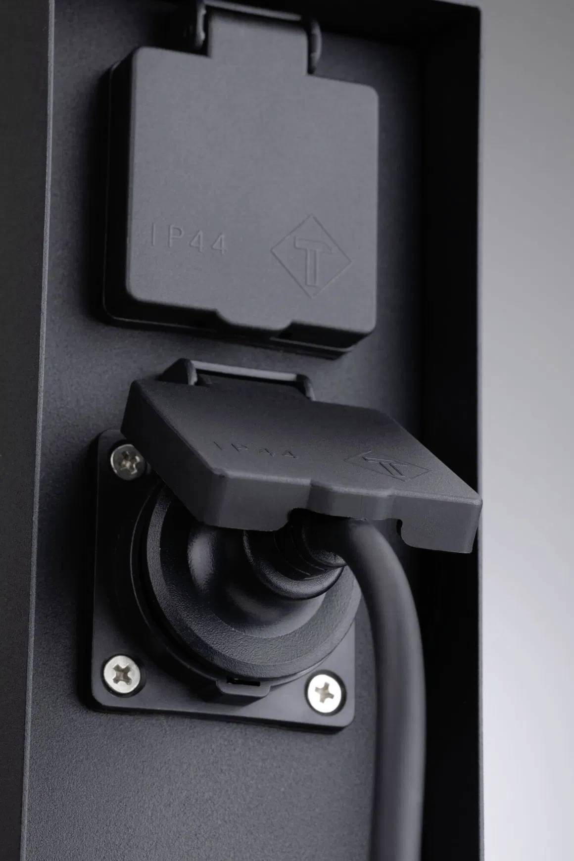 Black socket with plugged-in power cable; suitable for outdoor applications, IP44-rated for splash water protection.