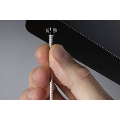 A finger pulls on a white cord emerging from a black casing.