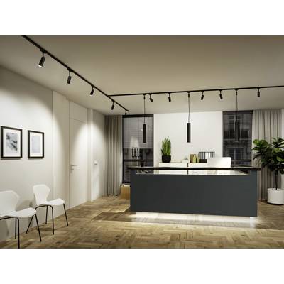 Modern kitchen with wooden flooring, island with black pendant lights and green decorative elements. White chairs against the wall.