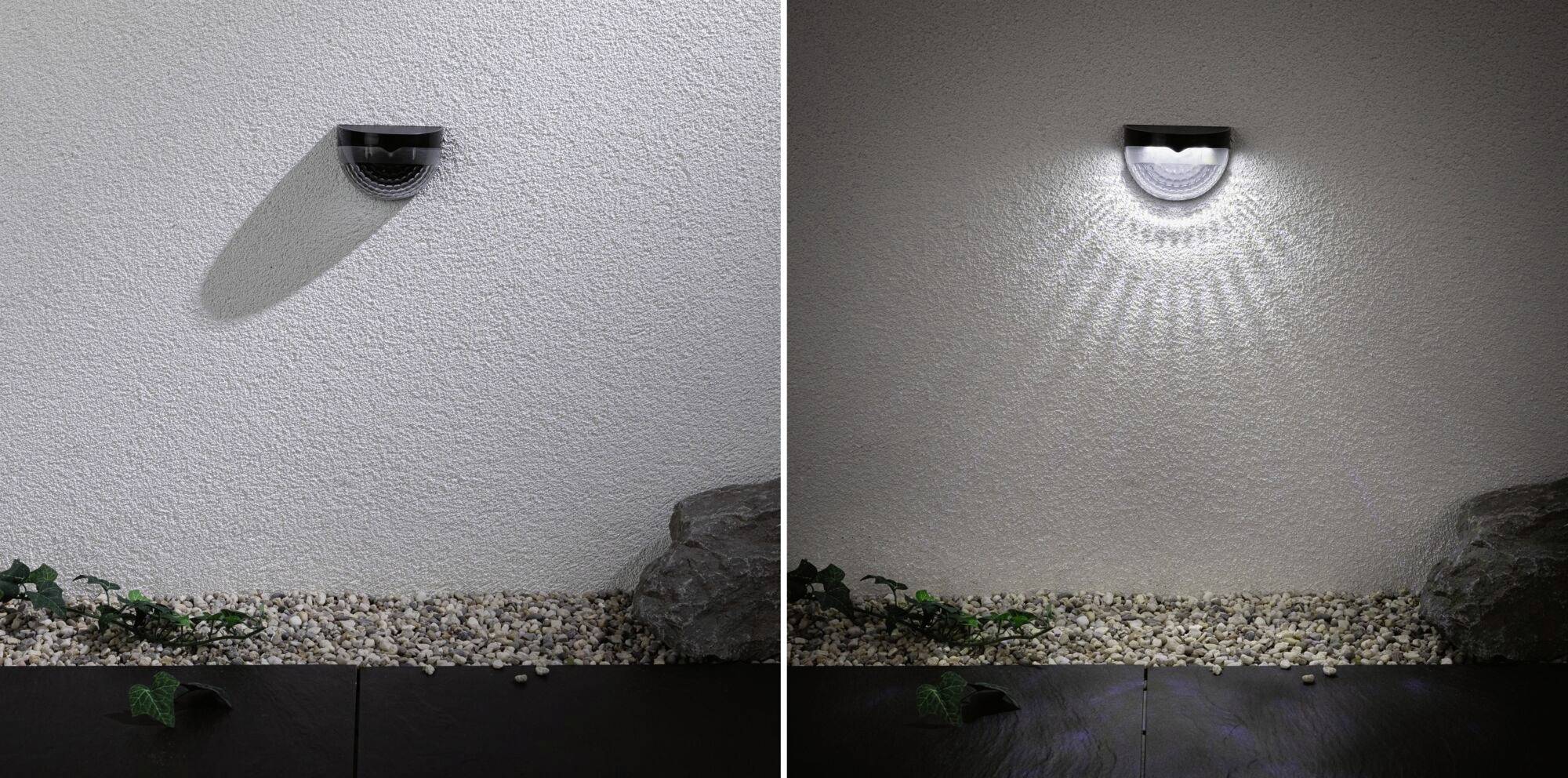 Two outdoor lights on a white wall above gravel and plants. On the left, the light is switched off, while on the right it is illuminating with a circular pattern.