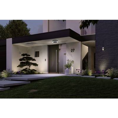 Modern house at dusk, illuminated entrance with stairs on the right, tree in the foreground, plants and house number 27 visible.