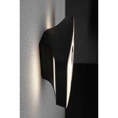 Black, contemporary wall light with indirect lighting, mounted on a grey wall, emitting a warm, diffused light.