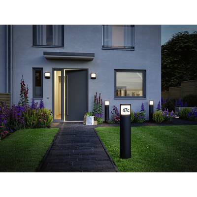A modern house with an open door, revealing an illuminated path and a garden with flowers. A sign displays '47c'.