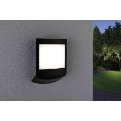 A contemporary exterior wall light with a square white light panel, mounted on a grey concrete wall. Trees are visible in the background.