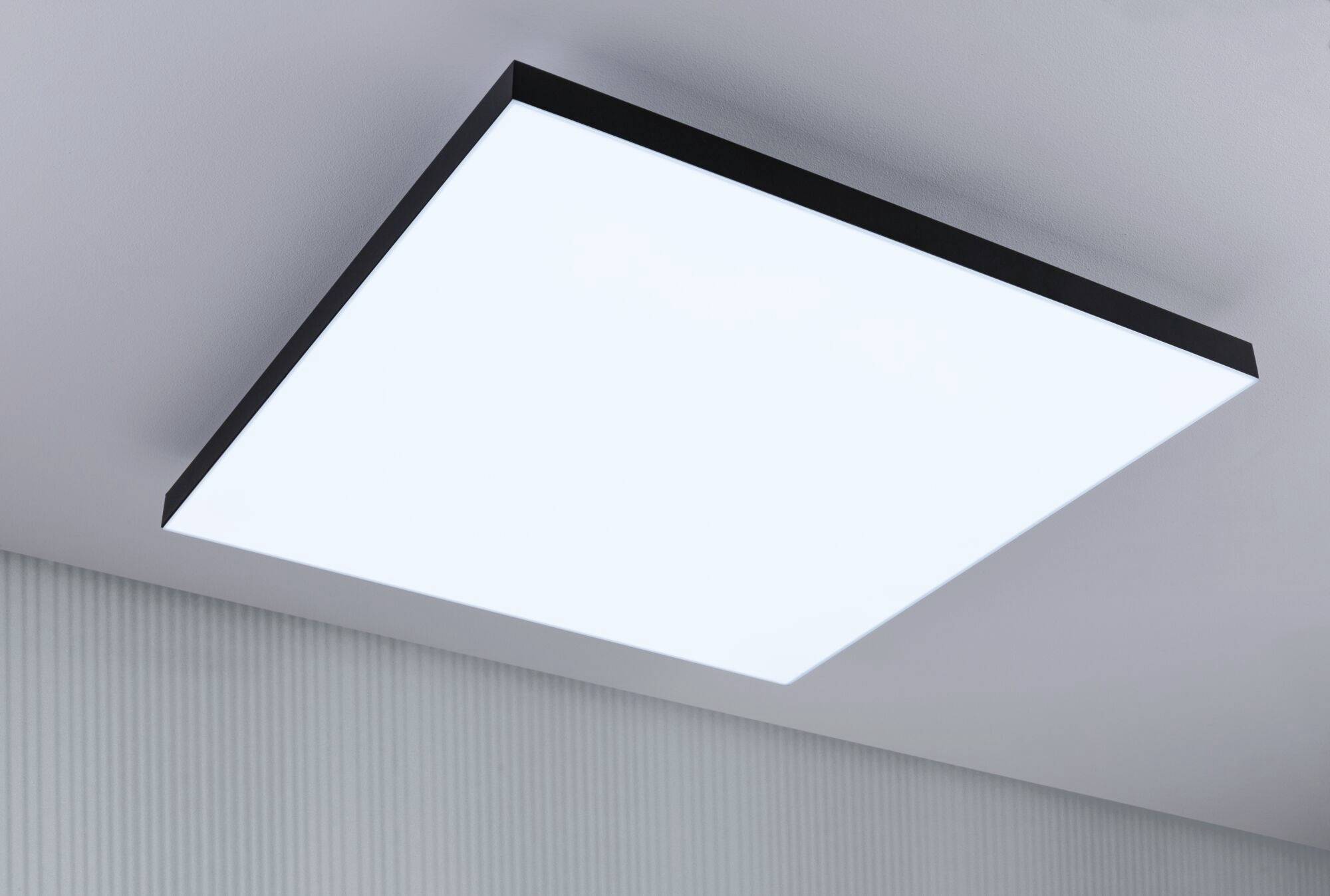 Ceiling light with a rectangular, slim design and bright, even illumination, mounted on a grey ceiling.