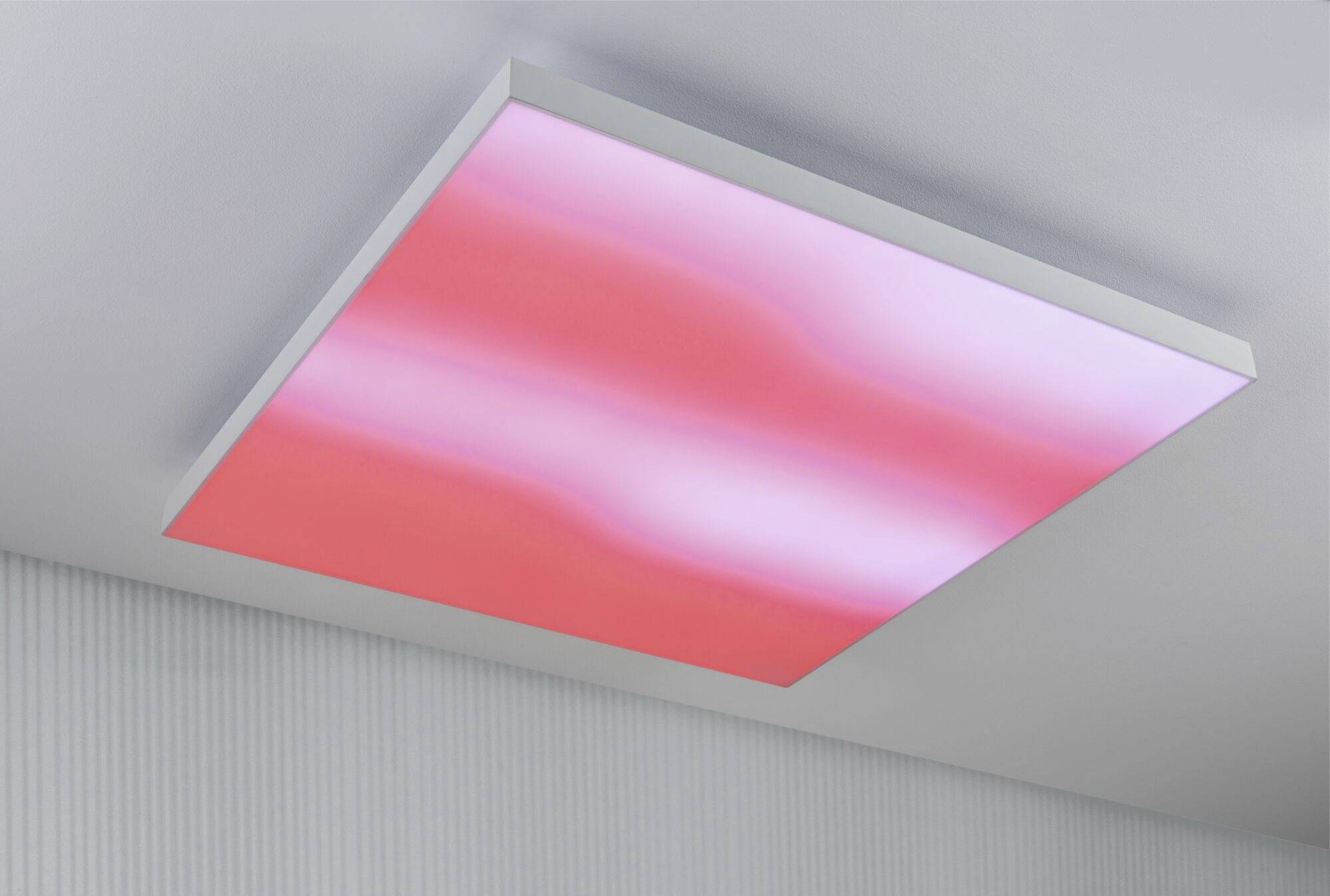 Illuminated ceiling panel in a room, shimmering in pink and white, creating a modern, calming atmosphere.