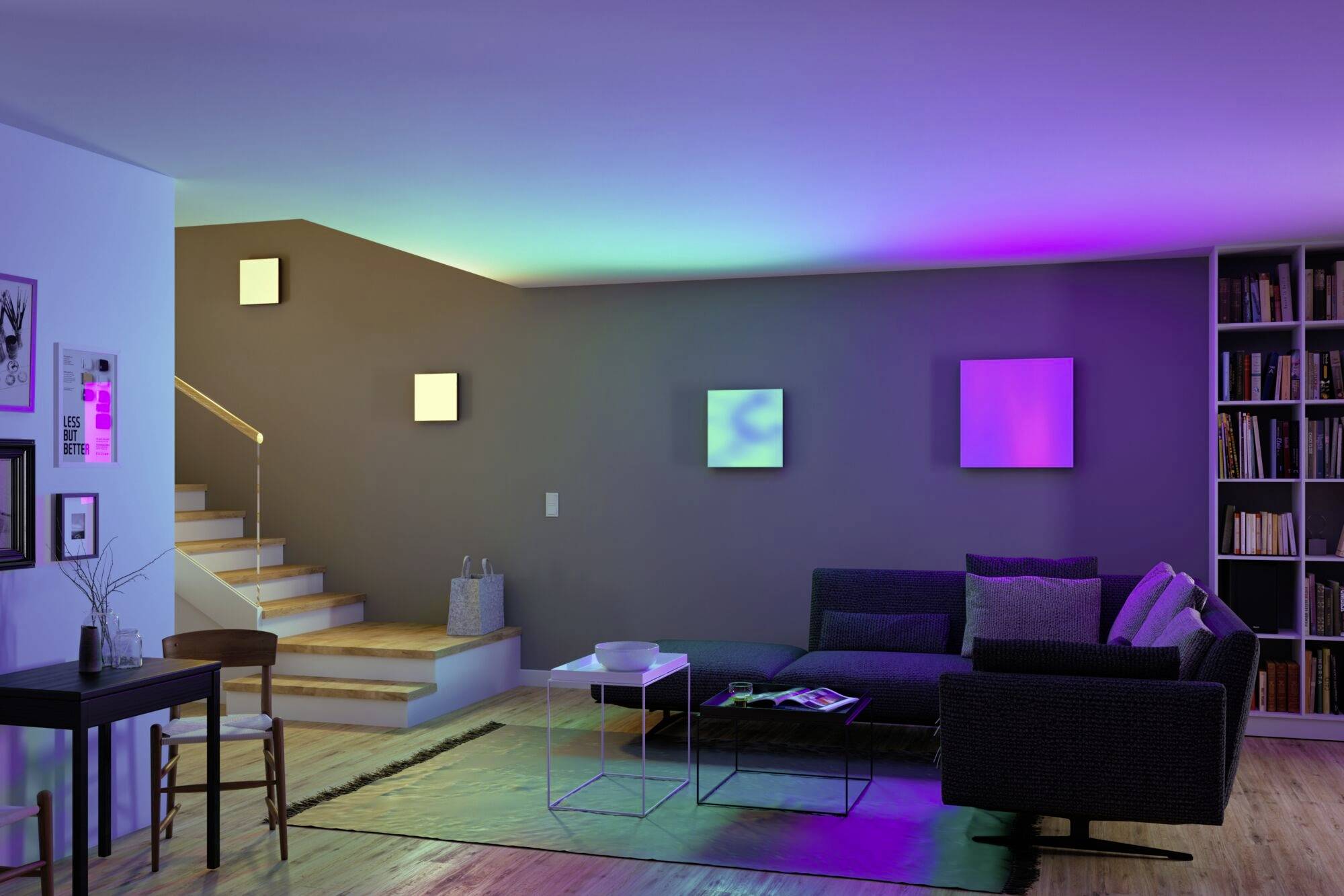 A modernly furnished living room with a sofa, a table and atmospheric, colourful wall lighting.
