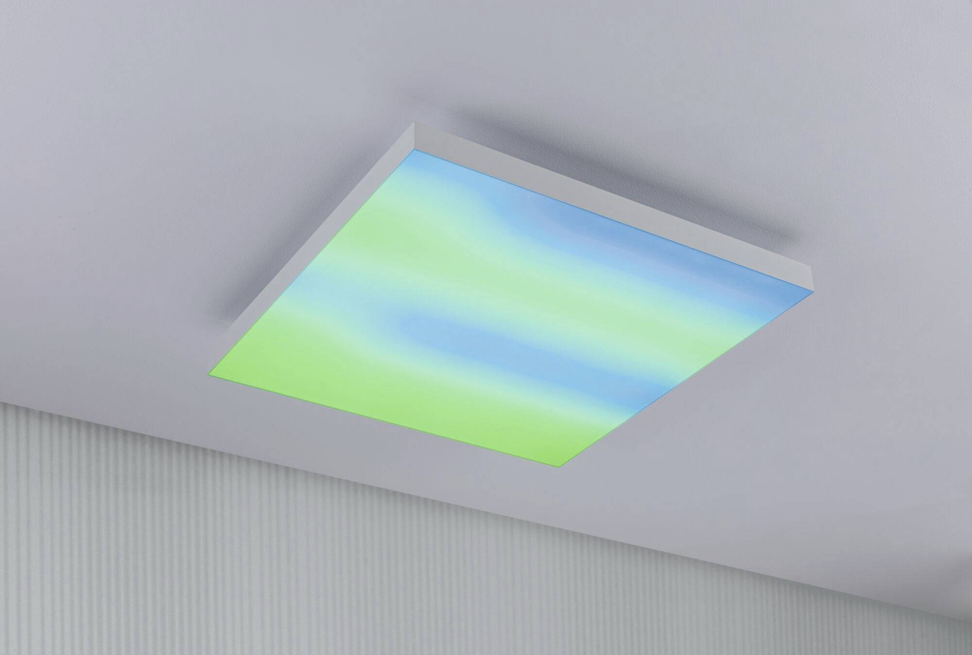 Rectangular ceiling light with a gradient from blue to green, mounted on a white ceiling in a modern room.