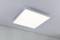 Rectangular ceiling light with a modern, minimalist design, emitting uniform light in a room with a white wall and grey ceiling.