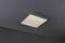 Rectangular ceiling light with a modern, minimalist aesthetic, providing warm, even illumination in a dimly lit room.