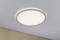 A round ceiling light with white light is mounted on the ceiling of a room. Below it is a beige wall.