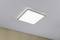 Square LED ceiling light, mounted on a white ceiling, emitting bright light. Beige wall in the background.