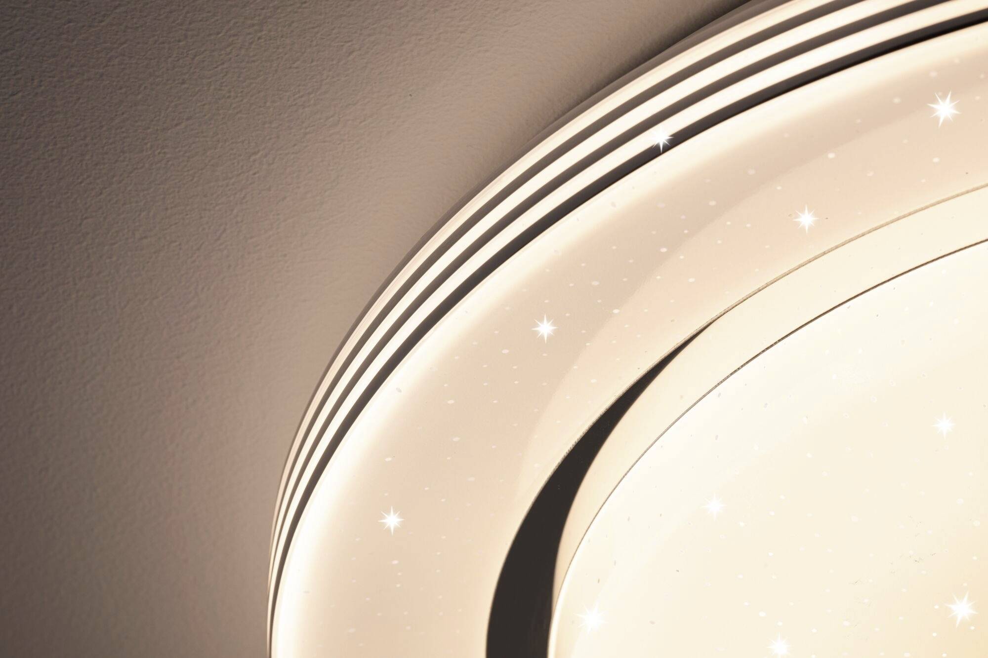Decorative ceiling light with a circular design and sparkling light effects.