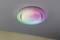 A round ceiling light displays a rainbow colour play.
