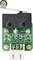 A microswitich with a lever, mounted on a small green printed circuit board with multiple connections and visible circuit components.
