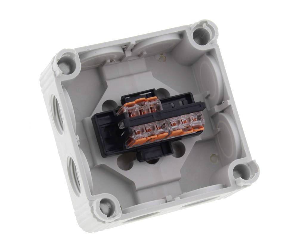 An electrical junction box with multiple openings and internal terminals, ready for installation or connection of electrical cables.