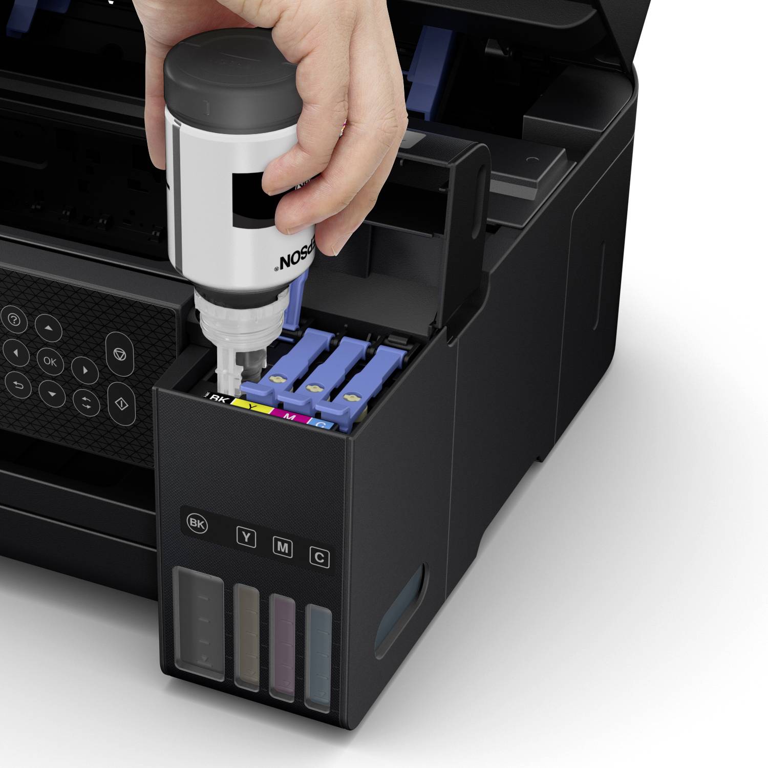 A hand fills black ink into a printer ink cartridge slot. The printer displays which colour cartridges are present.