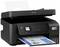 A black multifunction printer by Epson, printing a colour document. The device has a small display and keypad.