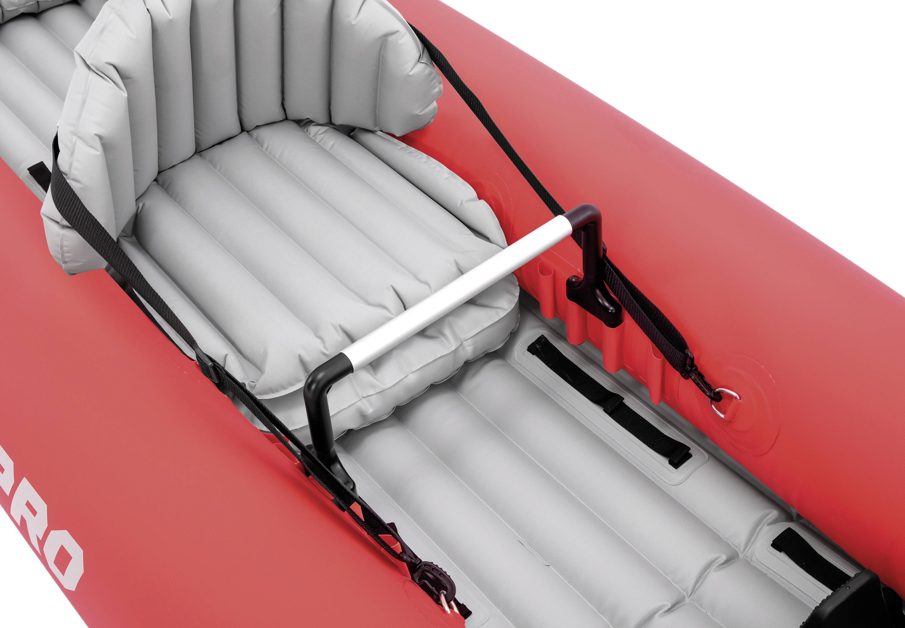 An inflatable red kayak with a grey seat and a central grab handle. In the background, a section of the kayak with strapping is visible.