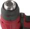 Close-up of a red hot air blower with a black handle. It shows the heating element and ventilation grilles.