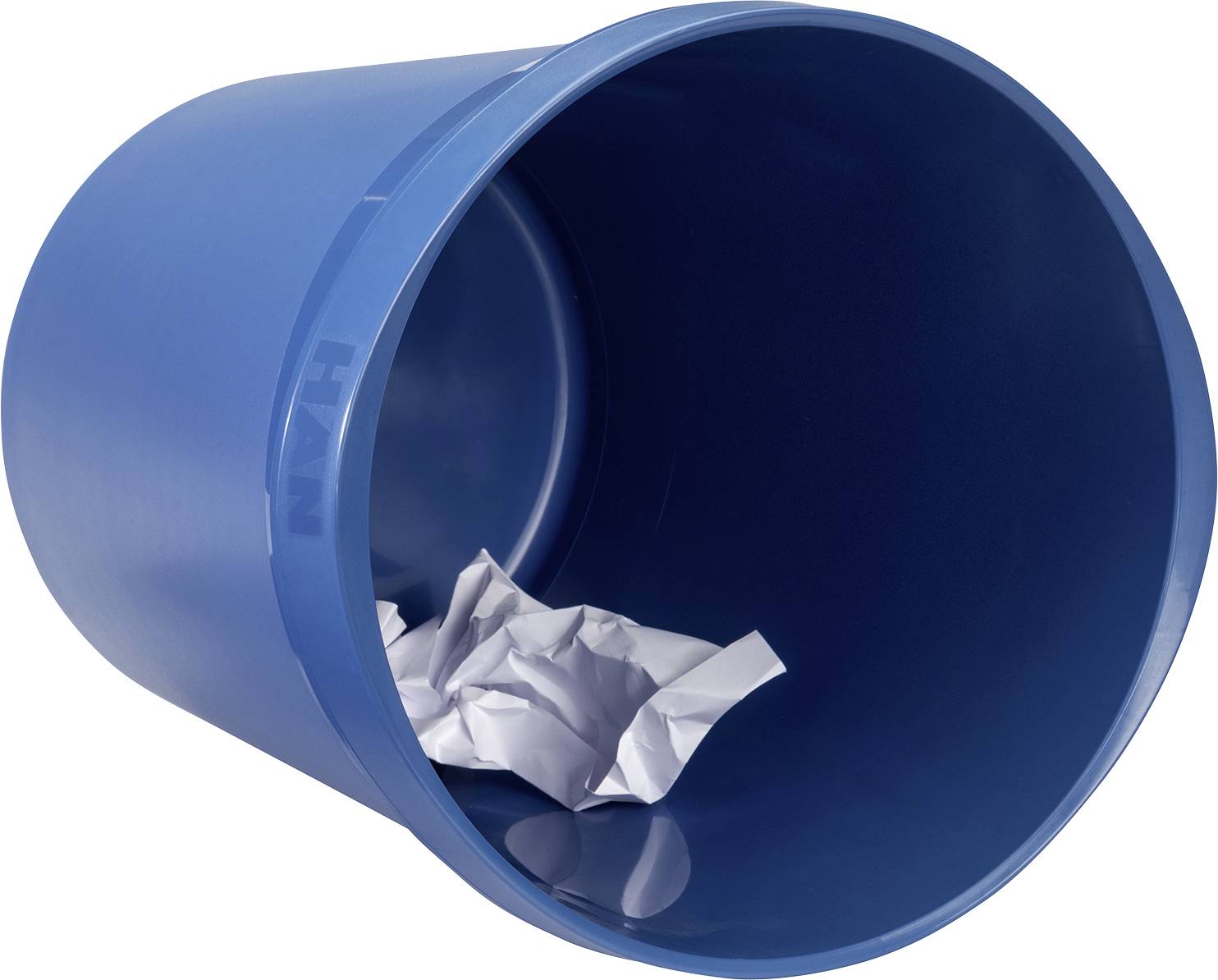 A blue wastepaper bin lies on its side, containing crumpled white paper.
