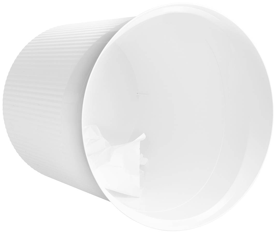 An empty white wastepaper bin lying on its side, with a small, crumpled piece of paper as its sole contents.