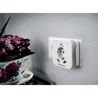 White socket with two USB ports on a grey wall; beside it sits a cup with a floral pattern and pink blossoms.