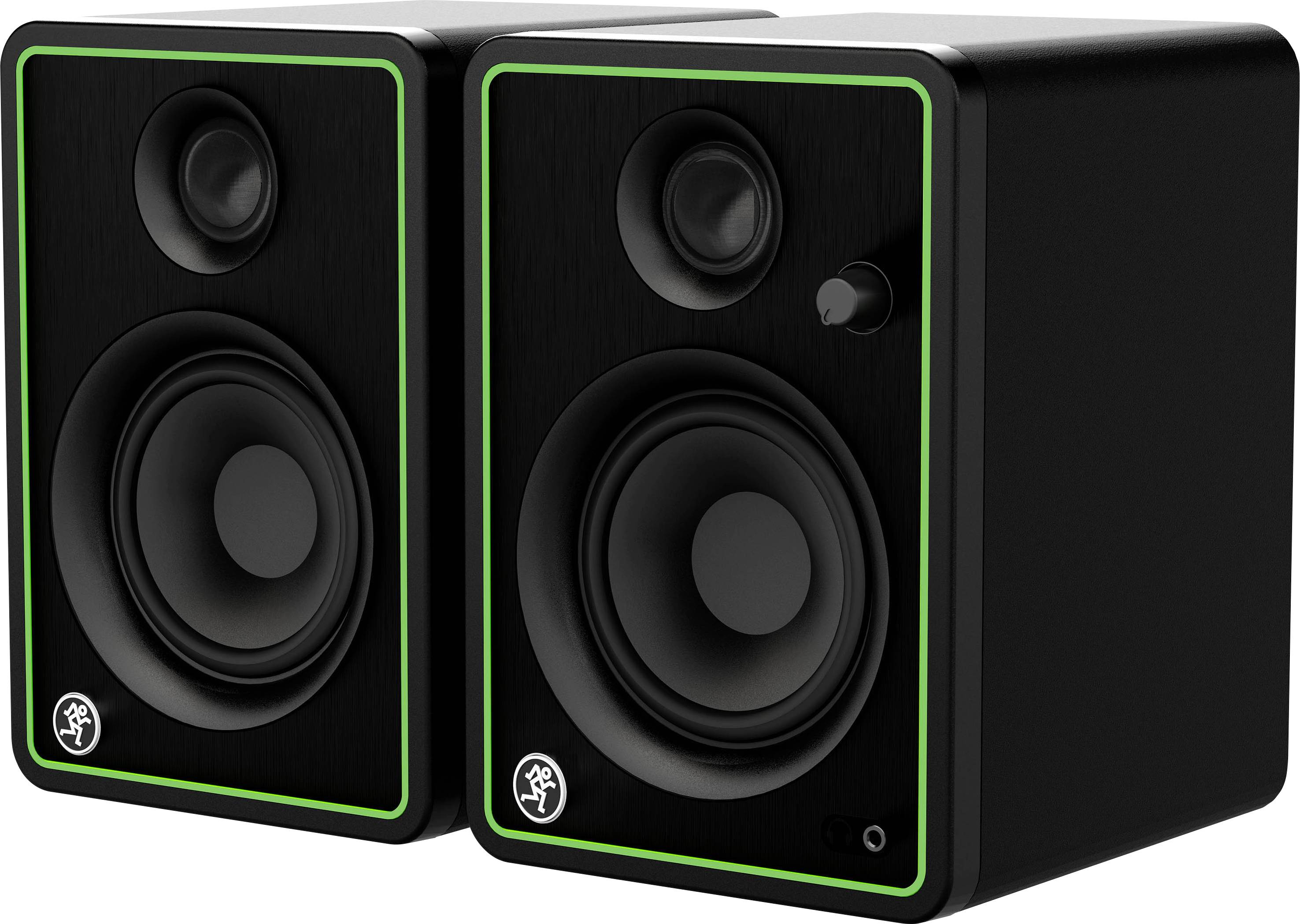 Two black speakers with green trim. The left speaker has an emblem at the bottom, the right speaker has a volume control.