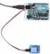An Arduino board is connected to a relay module. Cables provide the electrical connection between the components.
