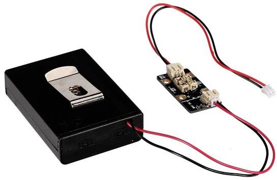 A black battery box with two red and black cables leading to a small circuit board. The circuit board has two connectors.