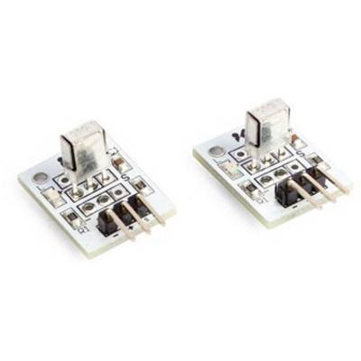 Two small electronic modules with plugs and marked pins for electrical connections, on a light surface.