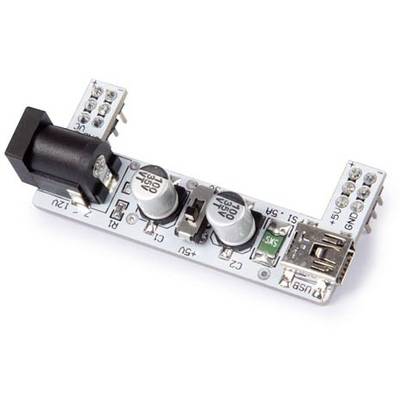 An electronic circuit board with multiple connectors, two large capacitors, a USB port, and power sockets.