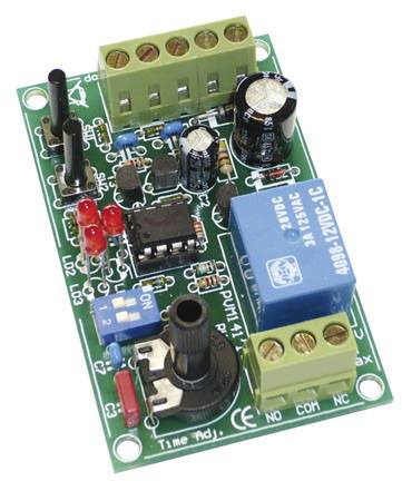 A green circuit board with numerous electronic components, including a blue relay, capacitors, and resistors.