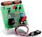 Electronic circuit kit with capacitors, resistors, diodes and battery terminal on green etched PCB.