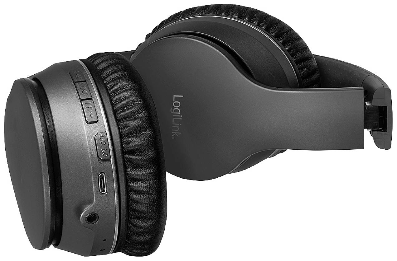 Black wireless headphones with padding and control buttons on the side, lying on a white background.
