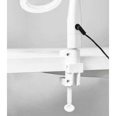 Close-up of a white lamp base with a clamp fitting. The lamp is attached to a table and connected with a cable.