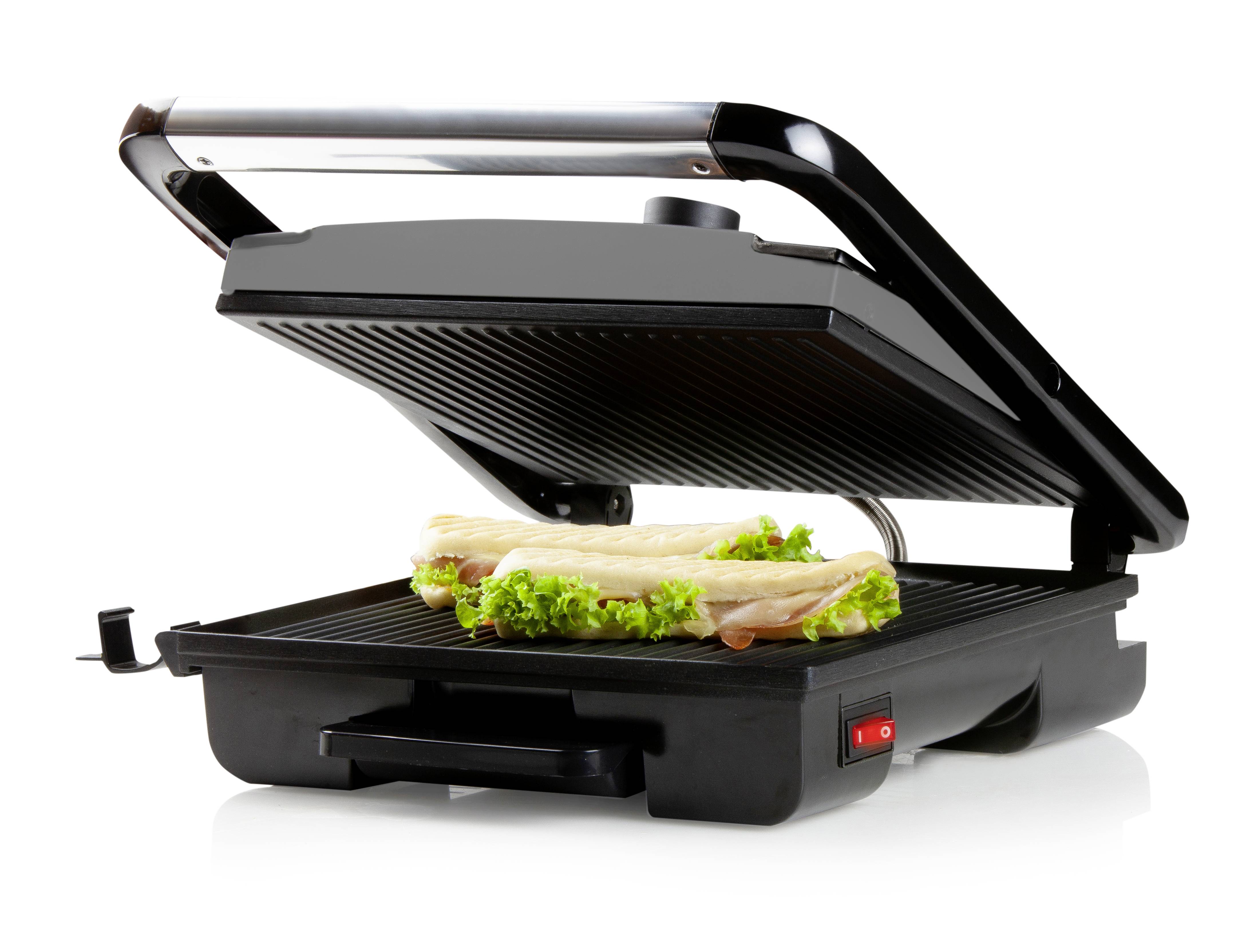 An electric contact grill with an open lid, containing two filled sandwiches with salad and cheese.