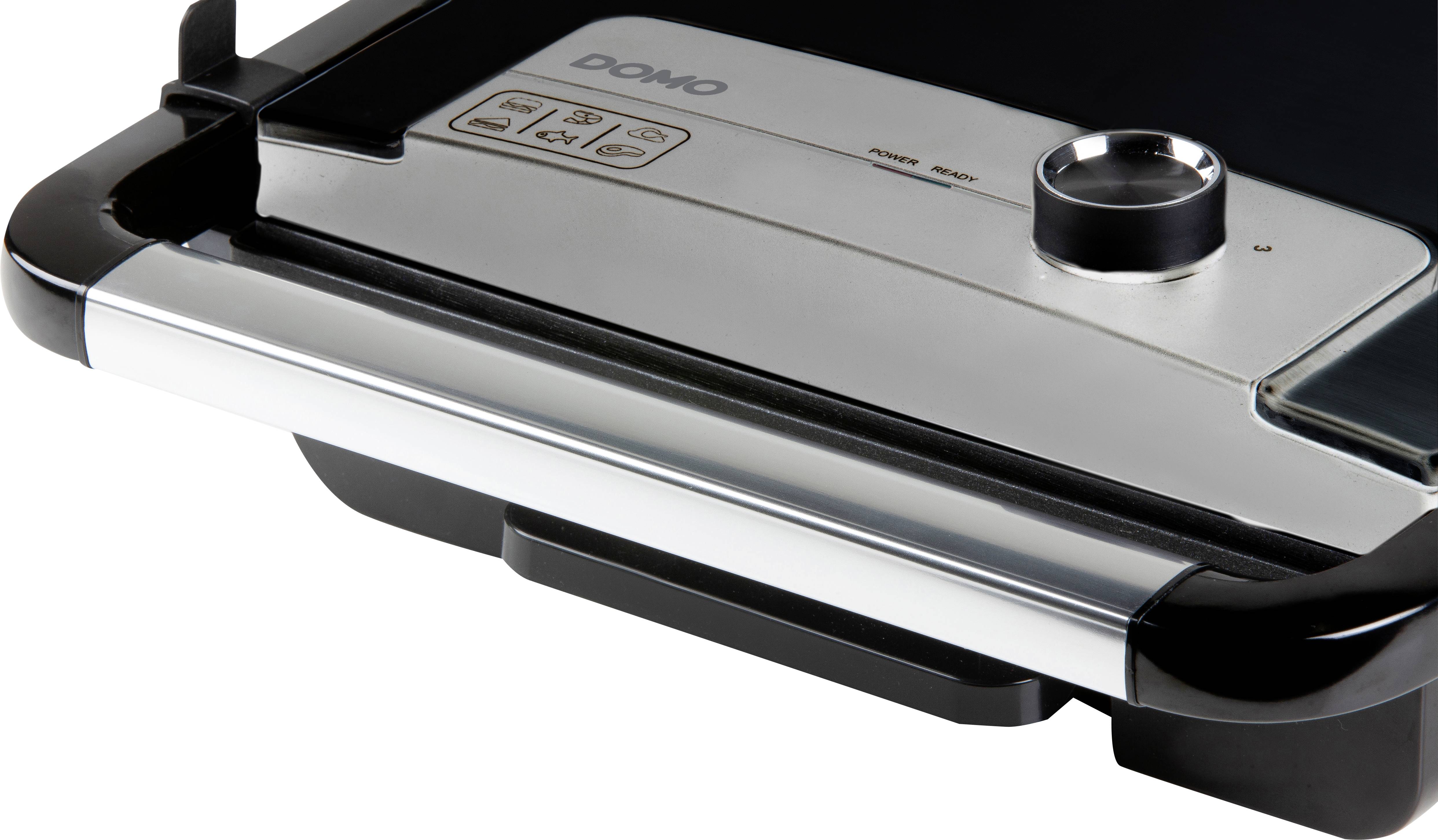 'Close-up of an electric tabletop grill with temperature controls and operation indicators.'