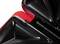 Close-up of a sandwich toaster with an open, triangular heating plate. The appliance is black with a red trim.