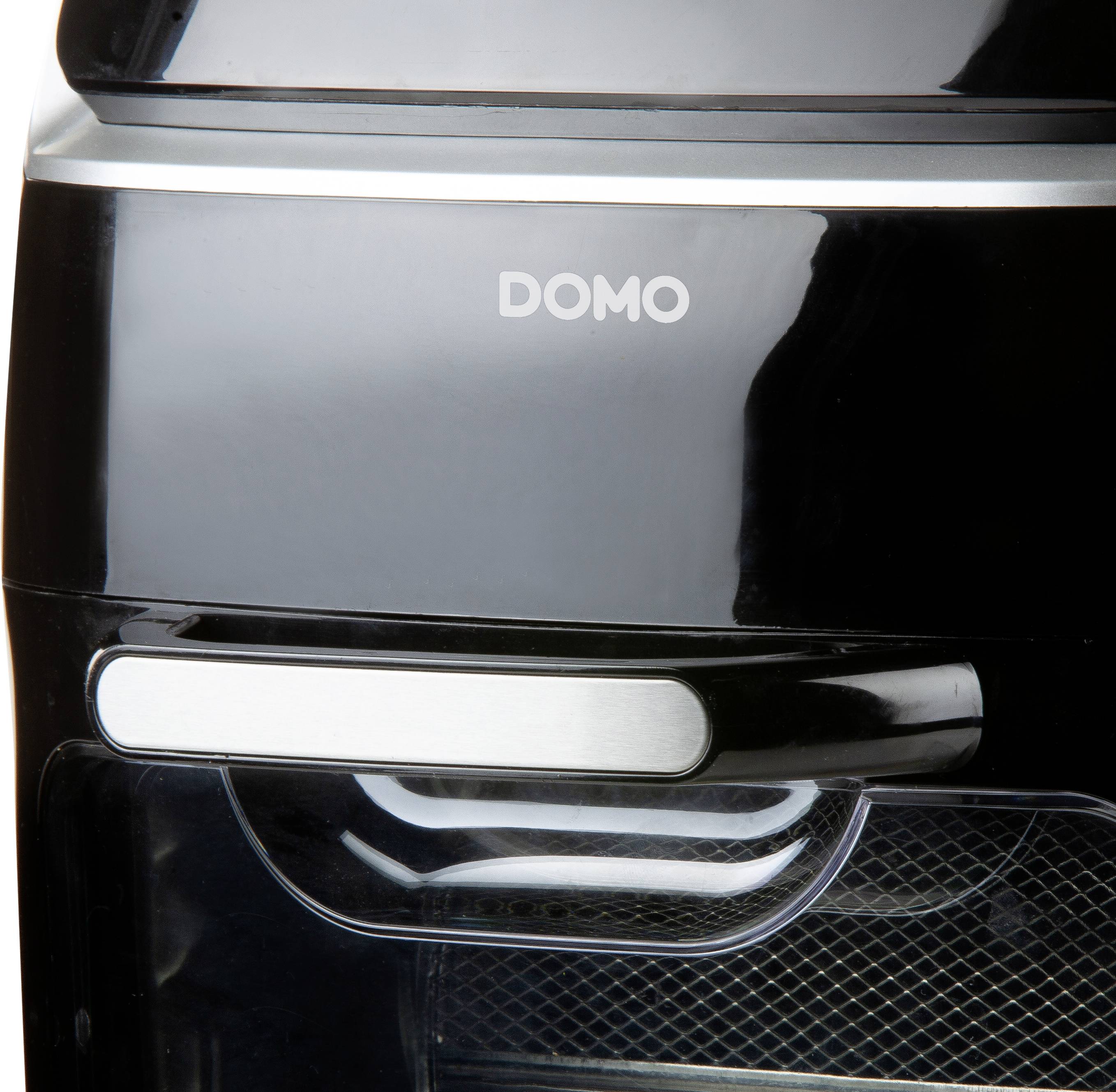 A black household appliance with a glossy surface and 'DOMO' written across the top. It has a handle strip on the front.
