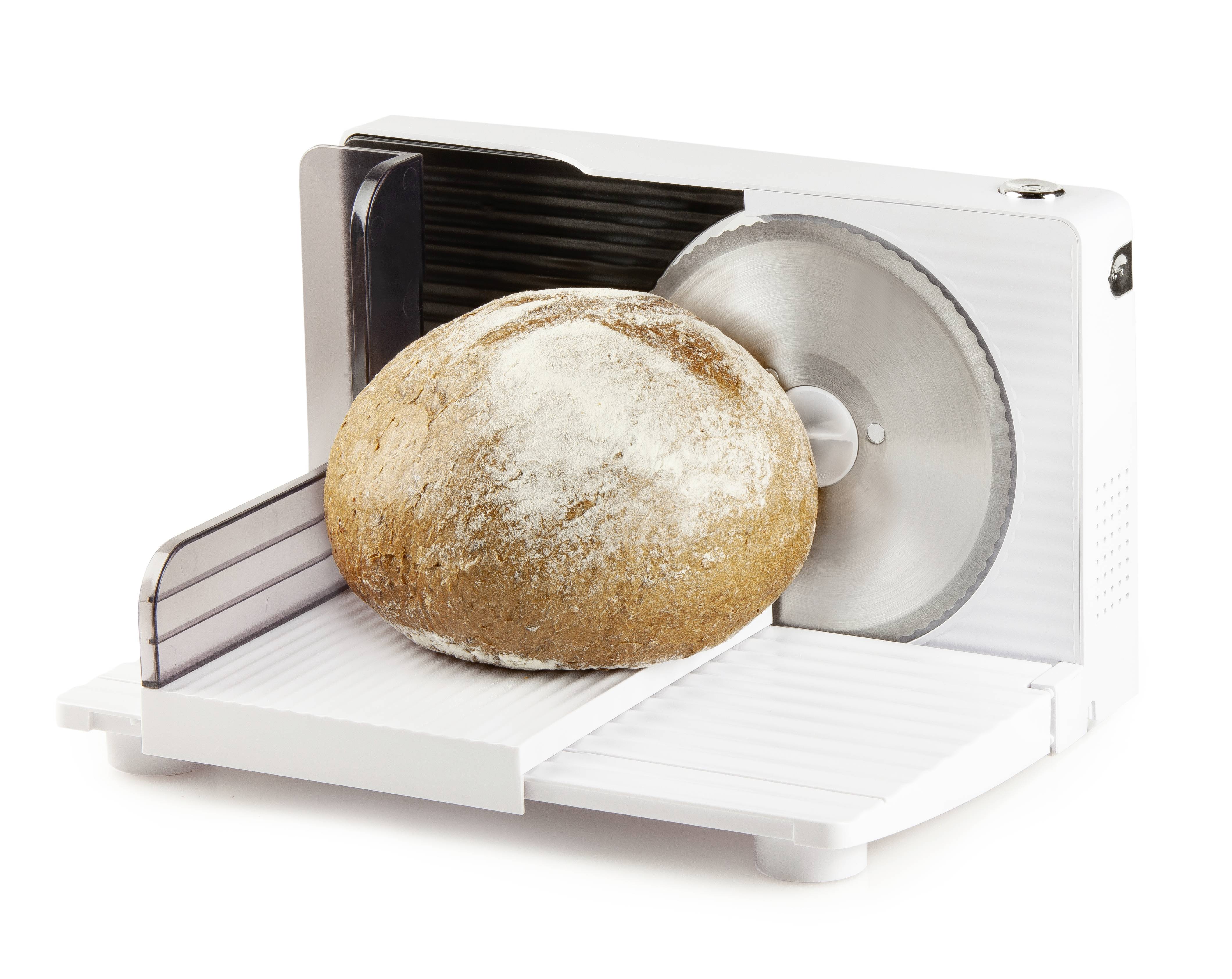 'A loaf of bread is being sliced on an electric bread slicer.'
