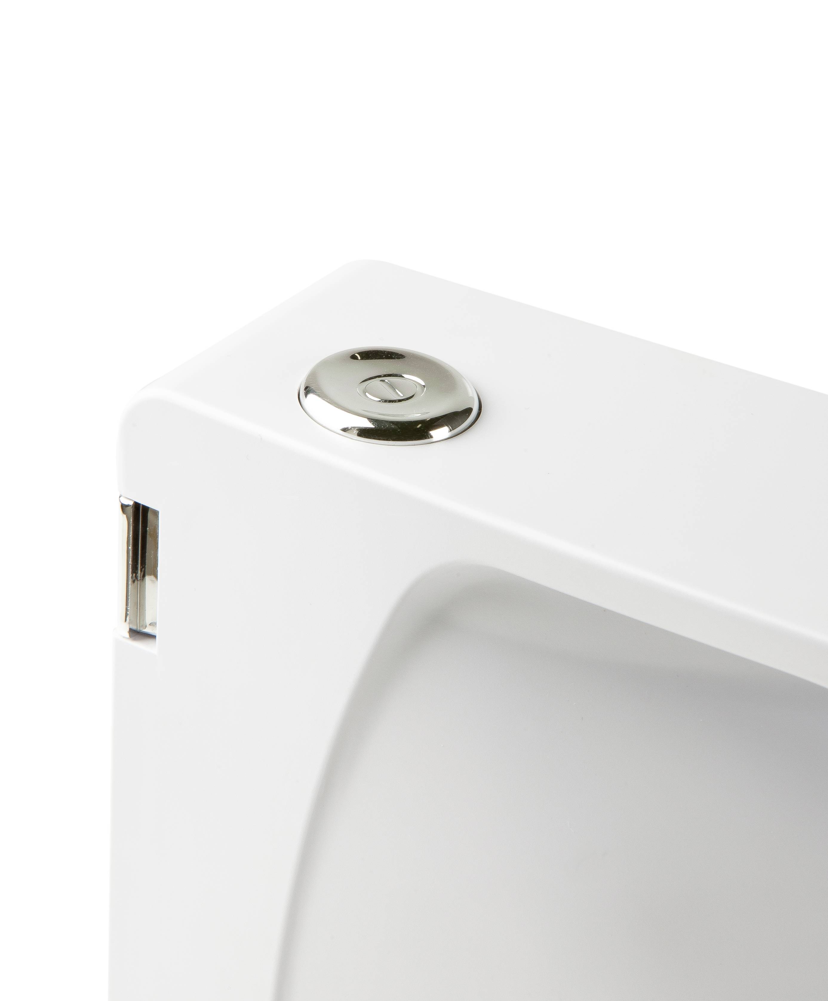 Close-up of a white toilet cistern with a shiny metal flush button. The tank has a smooth, modern surface.