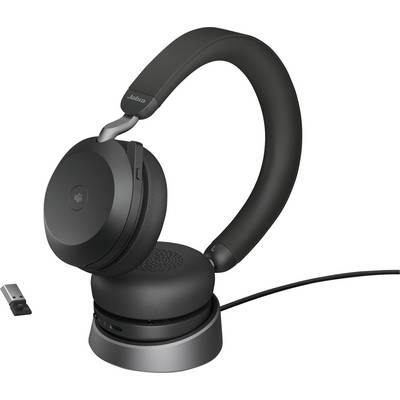 Wireless black Jabra headphones on a charging station, with a USB dongle beside them.