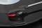Record player needle touches a vinyl record. The needle is black with a red marker and ensures audio output.