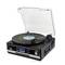 Record player with vinyl disc placed on top, transparent lid, blue digital display, and volume control on the front.