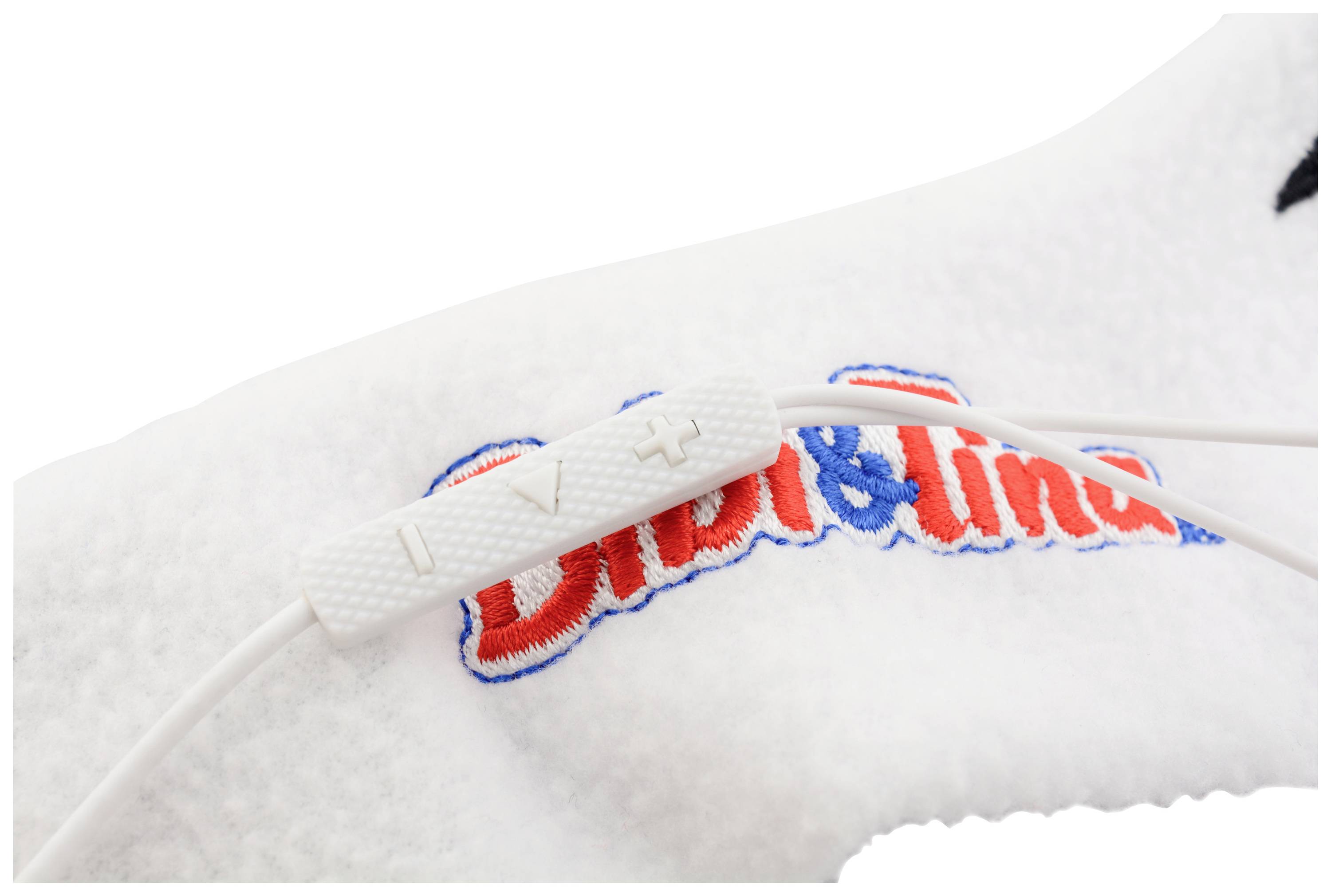 Close-up of a white headphone cable with volume control, against a white fabric background with a colourful logo.