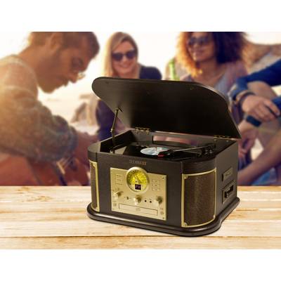 Music system in a vintage style on a wooden table, open with a vinyl record. People at the beach are blurred in the background.