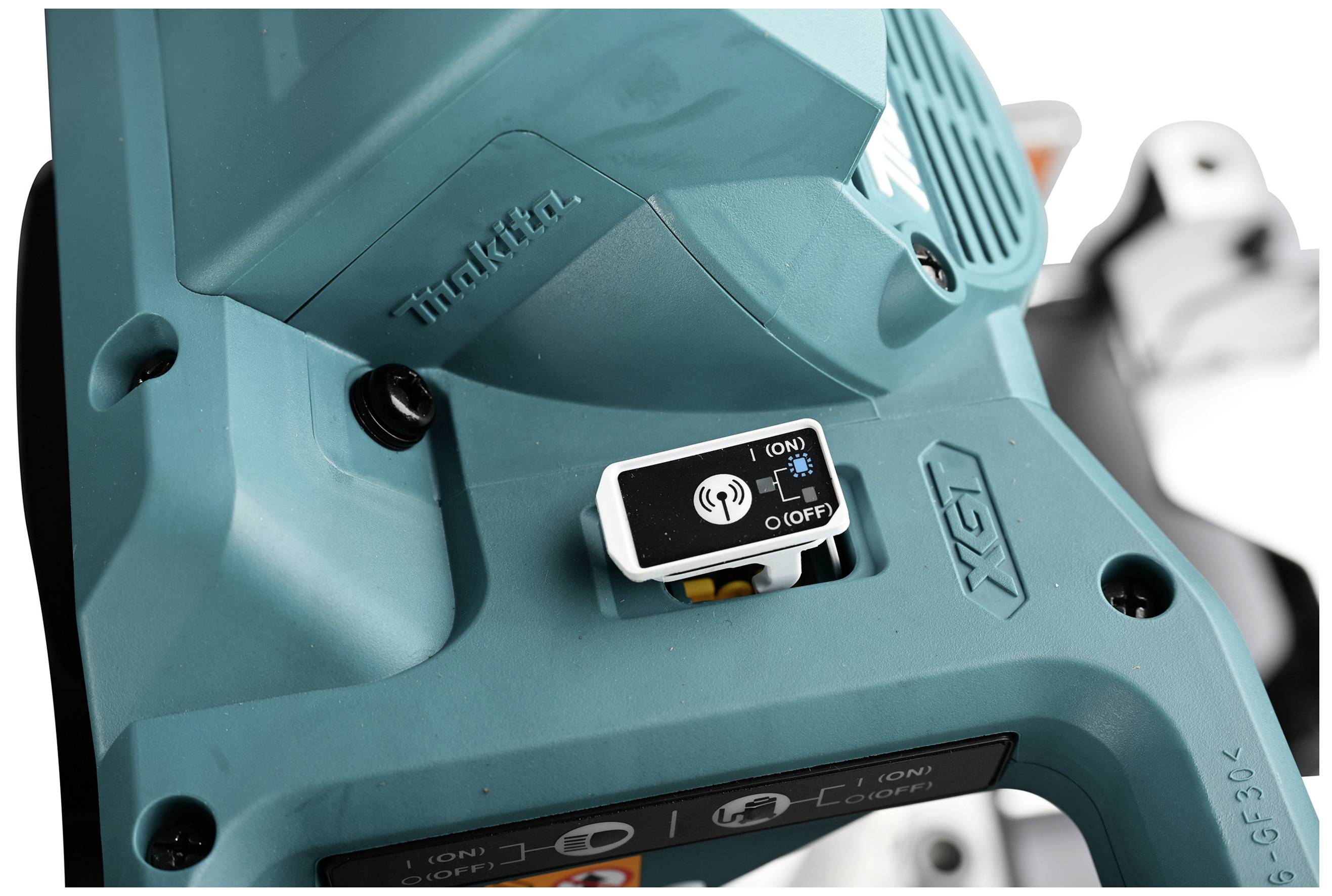 Close-up of a turquoise electric tool. The focus is on an on/off switch with the labels 'ON' and 'OFF'.