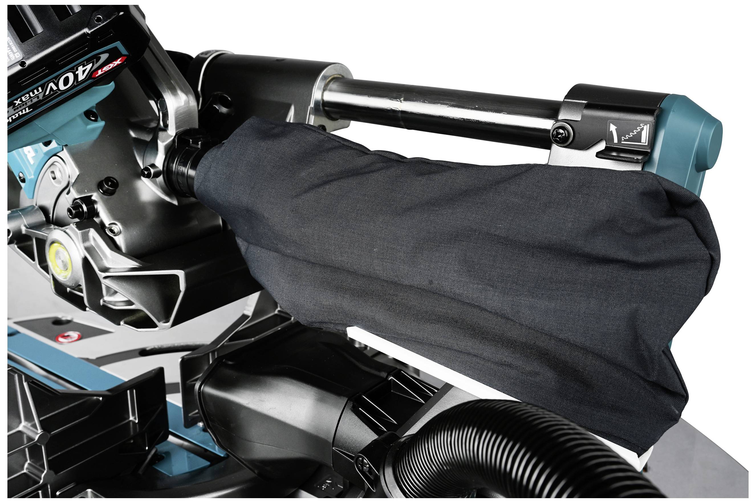 Image shows an electric saw with a protective cover over the saw blade arm. The device is situated in a workshop environment.